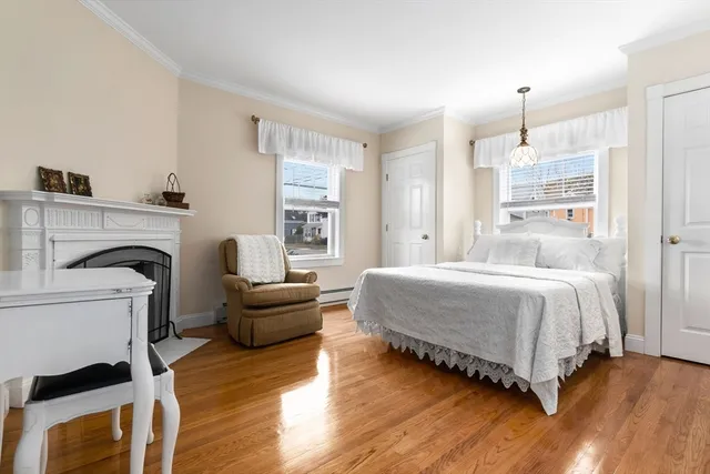 a spacious bedroom with a bed and a fireplace