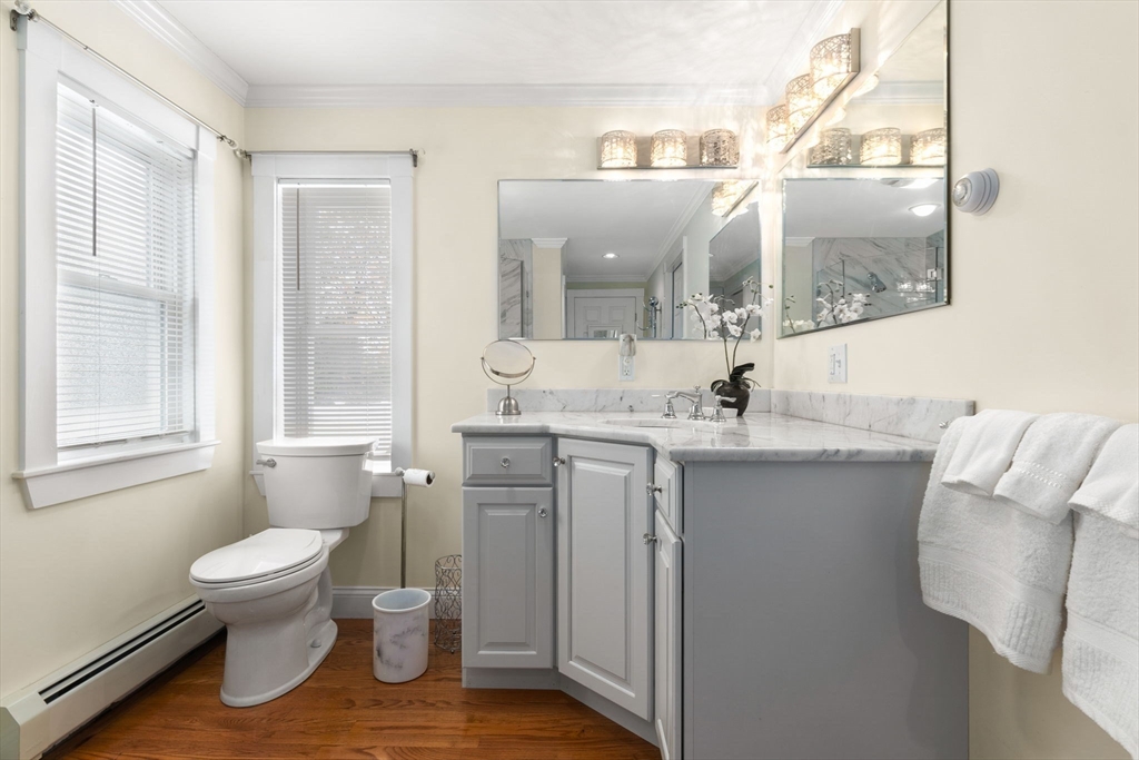 20 Ash Street, Unit 1 Danvers, MA 01923 - Photo 31 of 42 a bathroom with a toilet a sink and a window