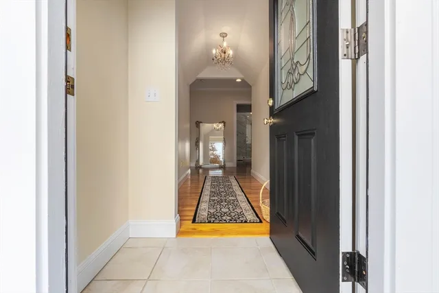 a room with wooden floor and a chandelier