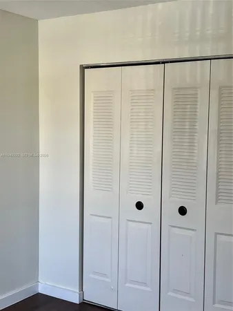 a white toilet sitting next to a white sink and vanity