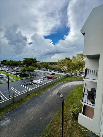 a view of swimming pool with outdoor seating and a tree