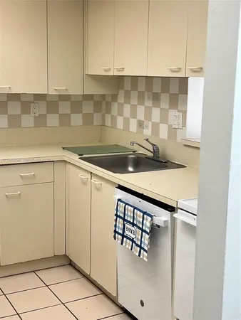 a kitchen with a sink and cabinets