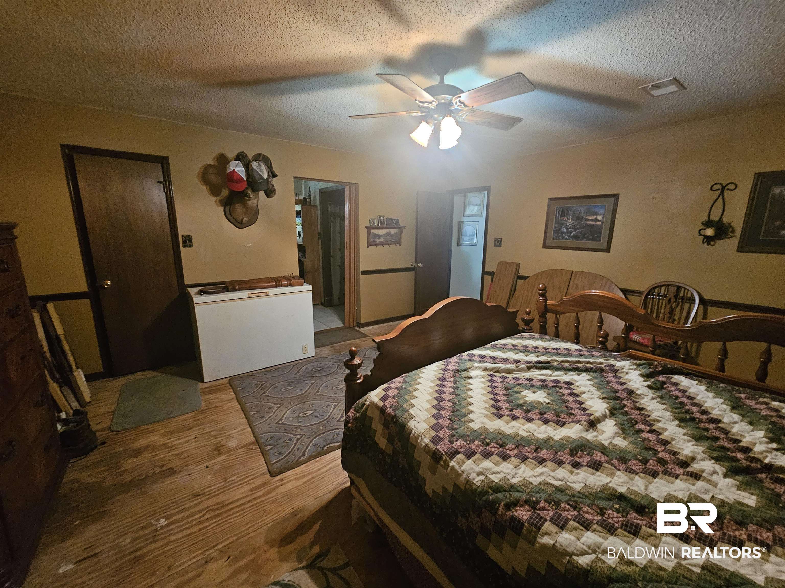 1818 Old Fannie Road Flomaton, AL 36441 - Photo 14 of 20 Bedroom with wood finished floors, a textured ceiling, and a ceiling fan