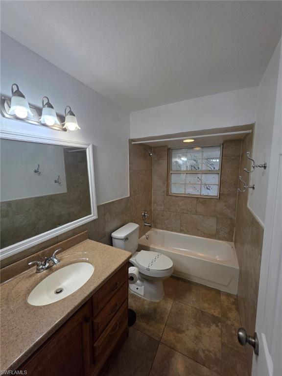2103 Unity Avenue Fort Myers, FL 33901 - Photo 22 of 40 a bathroom with a double vanity sink toilet mirror and bathtub