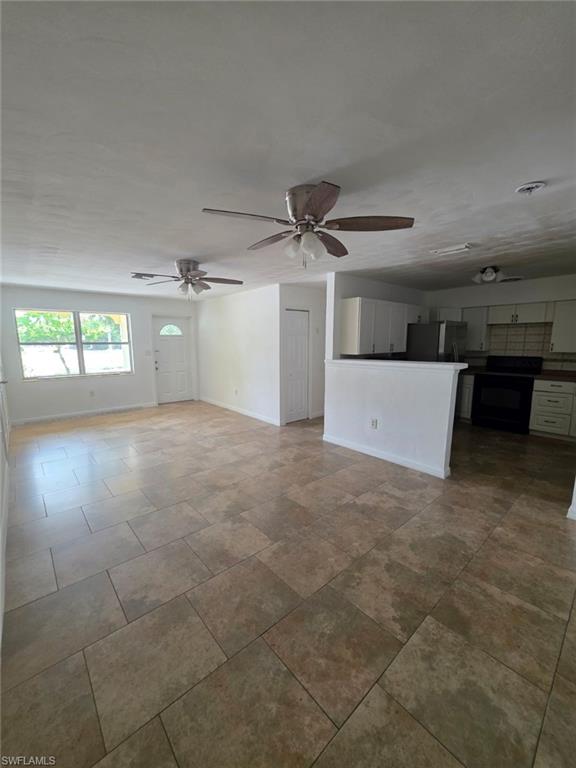 2103 Unity Avenue Fort Myers, FL 33901 - Photo 9 of 40 an empty room with windows and natural light
