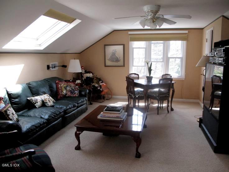 13 Georgetowne North, Unit 13 Greenwich, CT 06831 - Photo 11 of 17 a living room with furniture a chandelier furniture and a window