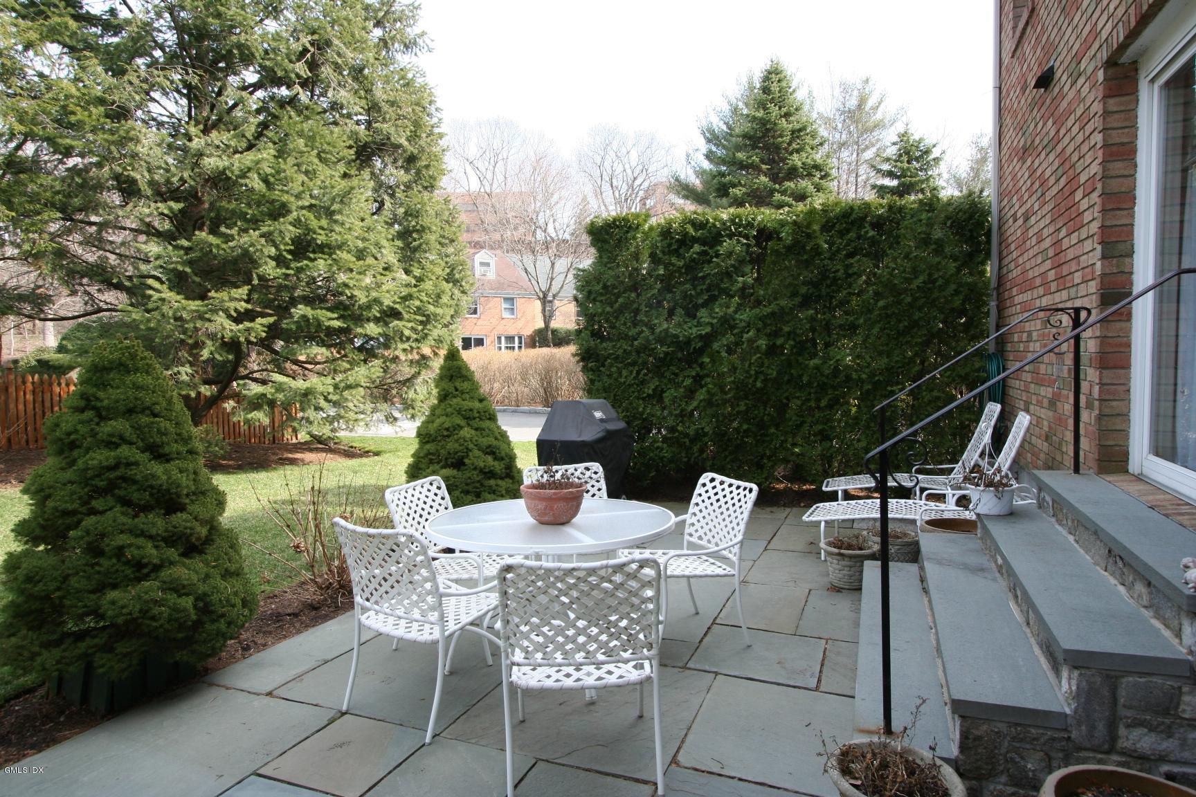 13 Georgetowne North, Unit 13 Greenwich, CT 06831 - Photo 14 of 17 a view of a patio with table and chairs and potted plants