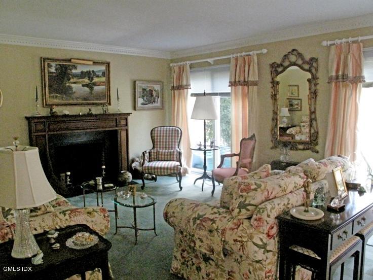 13 Georgetowne North, Unit 13 Greenwich, CT 06831 - Photo 6 of 17 a living room with furniture a fireplace and a table