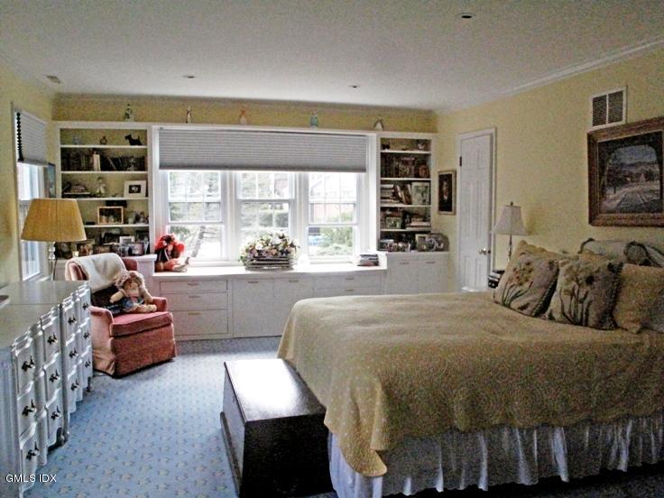 13 Georgetowne North, Unit 13 Greenwich, CT 06831 - Photo 9 of 17 a bedroom with a bed couch and a large window