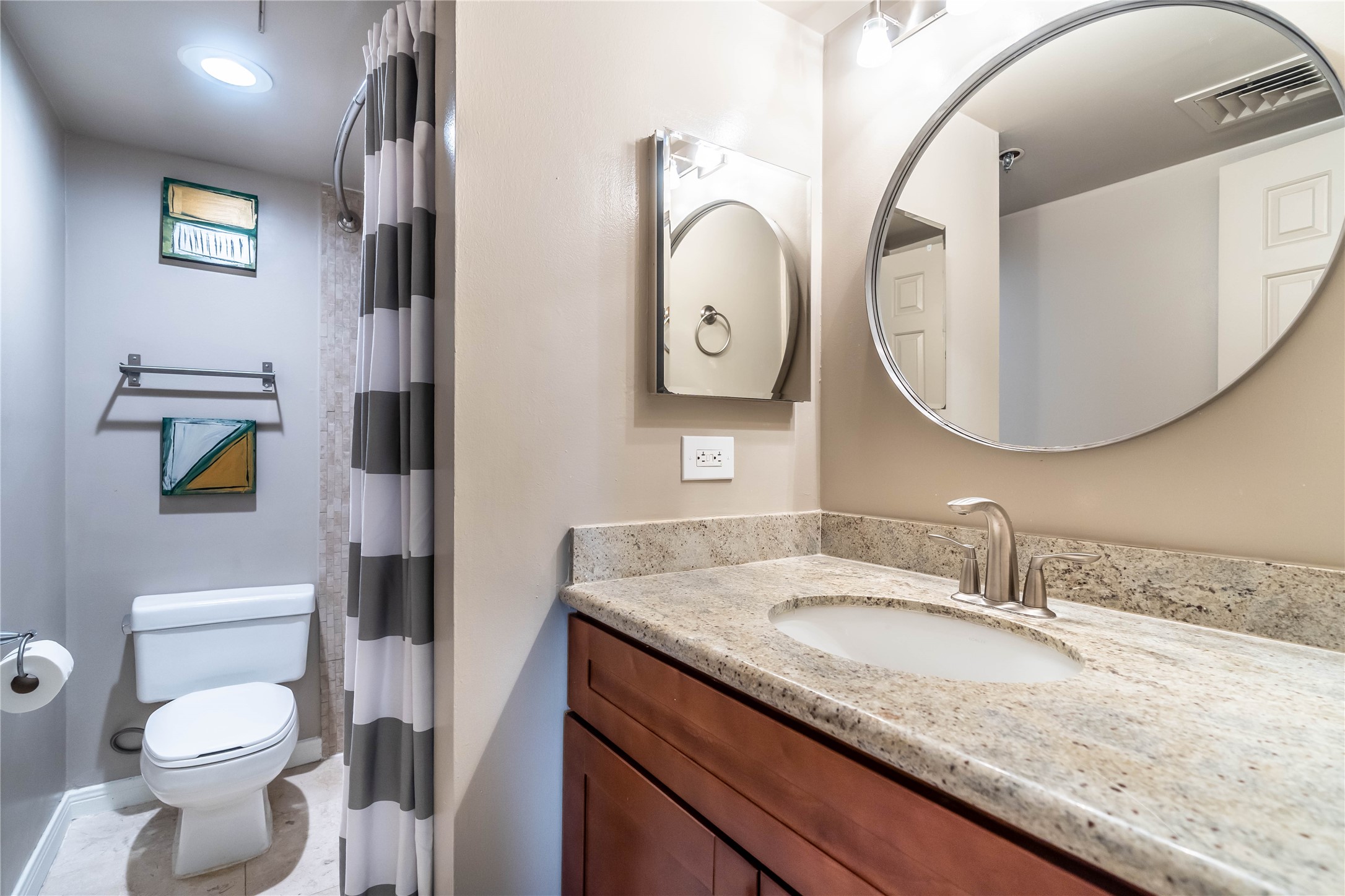 3525 Sage Road, Unit 1009 Houston, TX 77056 - Photo 16 of 23 a bathroom with a granite countertop toilet sink and mirror