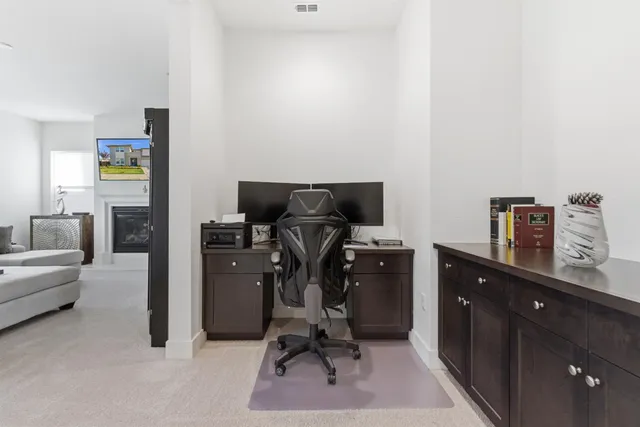 a view of workspace with furniture and wooden floor