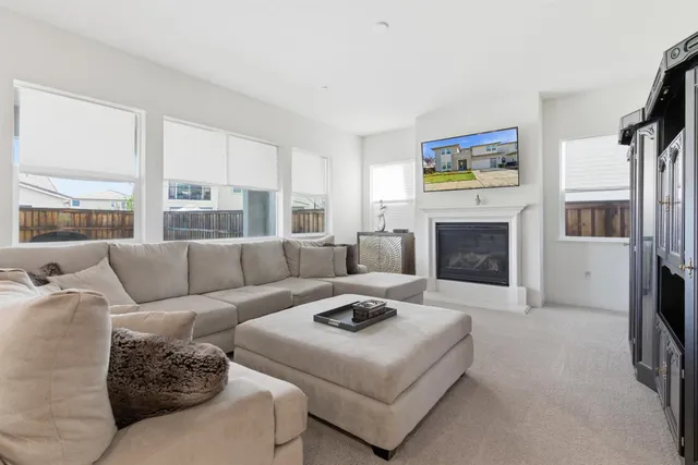 a living room with furniture flat screen tv and a fireplace