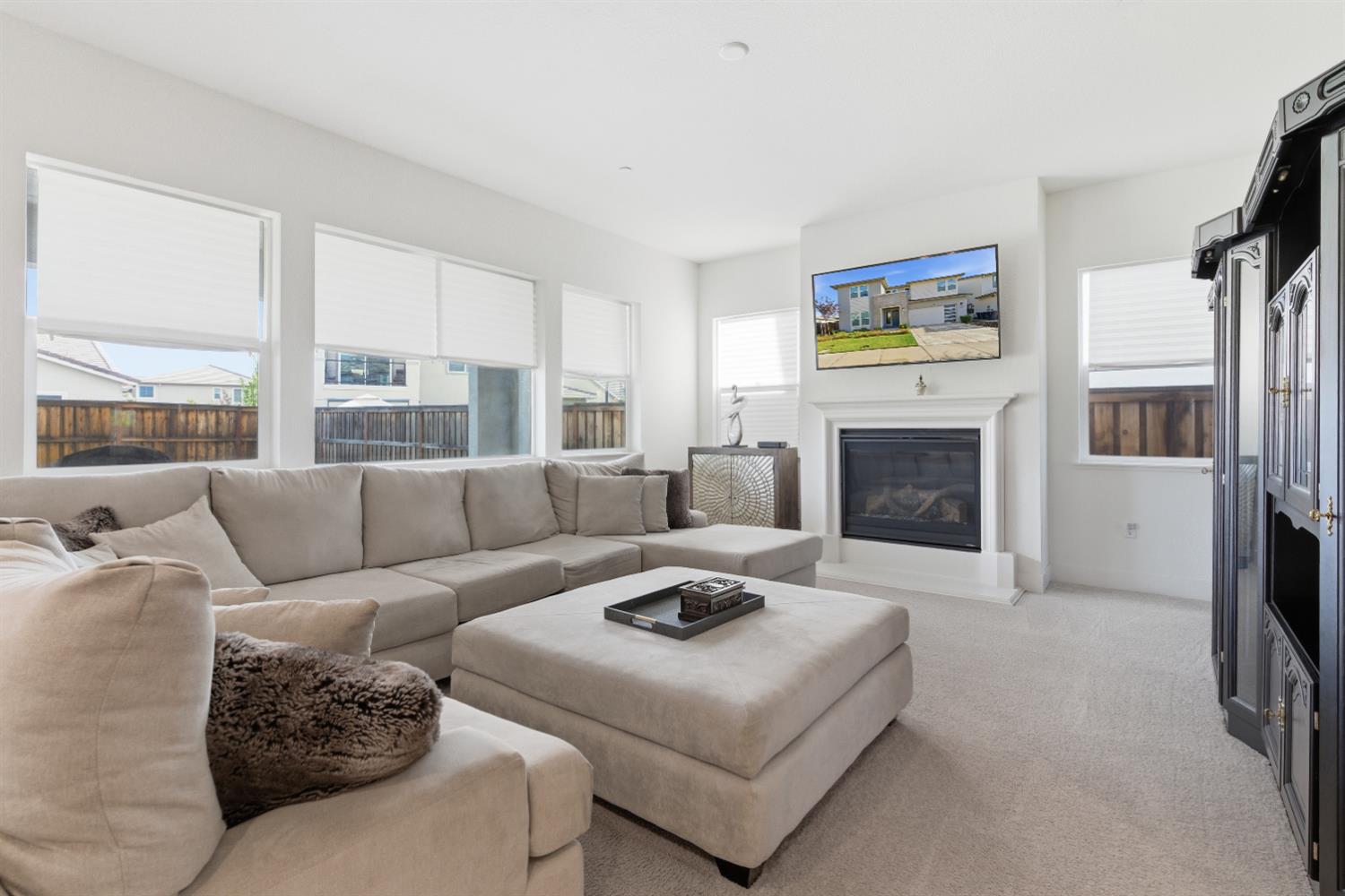 3233 Kipling Drive Lathrop, CA 95330 - Photo 11 of 39 a living room with furniture flat screen tv and a fireplace