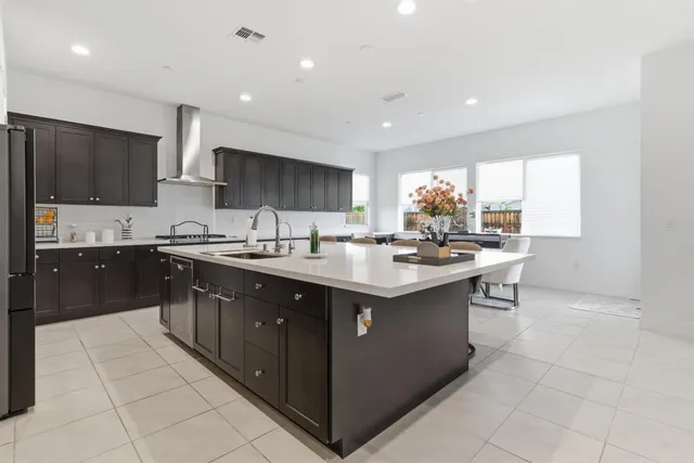 a kitchen with stainless steel appliances granite countertop a sink counter space cabinets and a large window