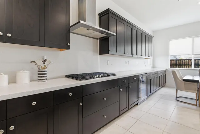a kitchen with refrigerator and cabinets