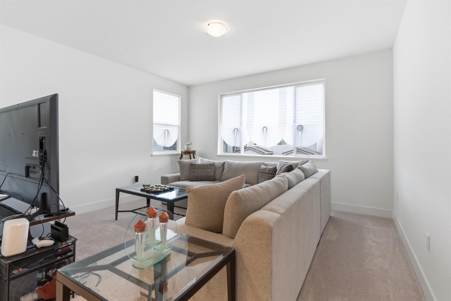 3233 Kipling Drive Lathrop, CA 95330 - Photo 22 of 39 a living room with furniture and a flat screen tv