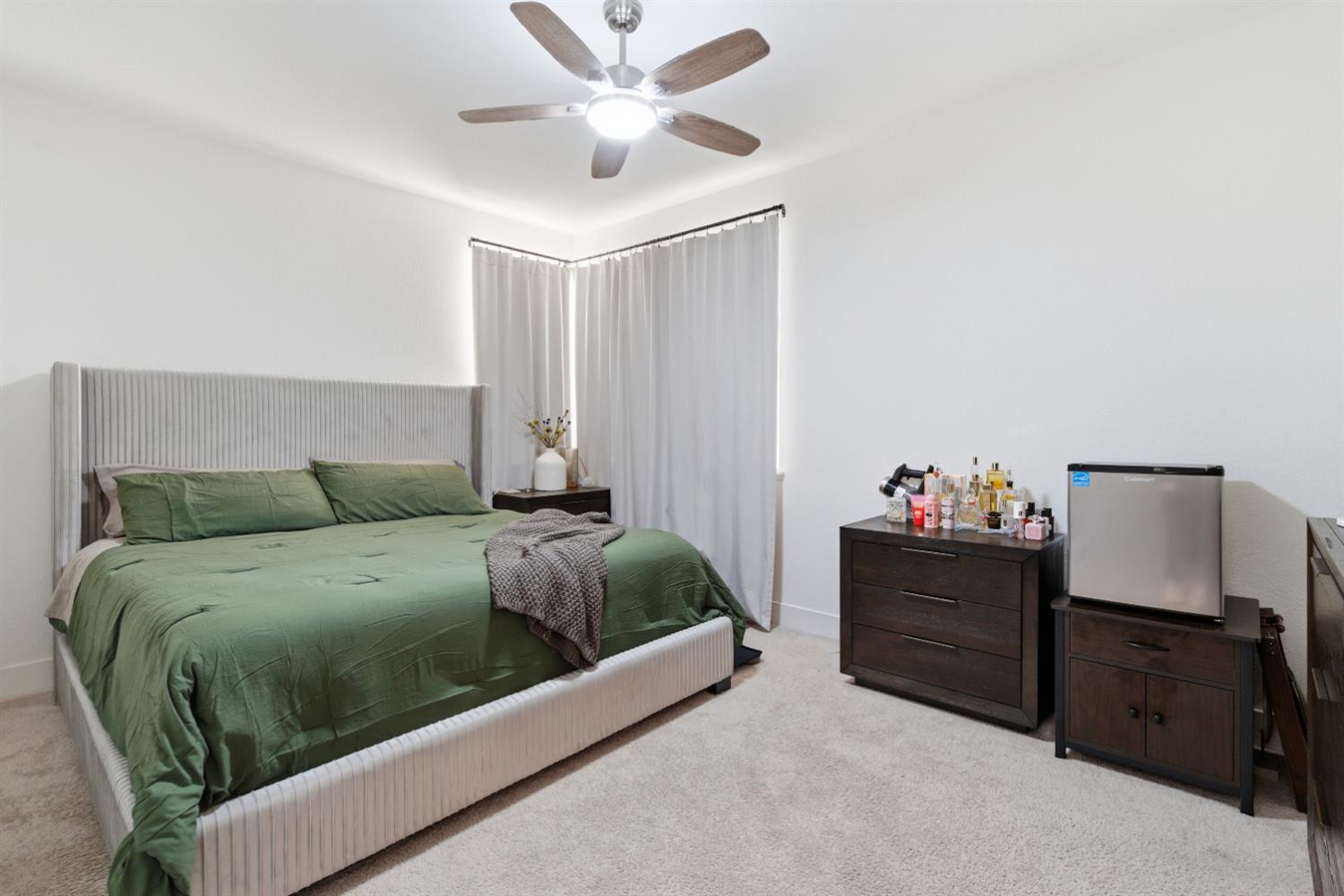 3233 Kipling Drive Lathrop, CA 95330 - Photo 26 of 39 a living room with a bed and a lamp
