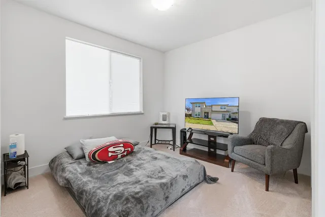 a living room with a bed and a lamp