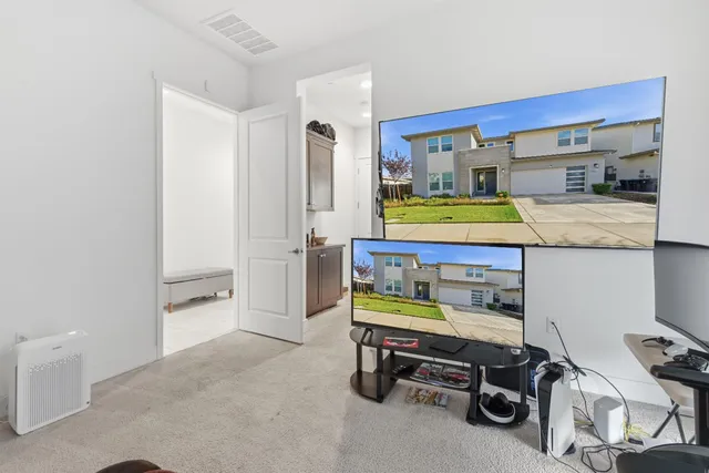 an empty room with windows and cabinet