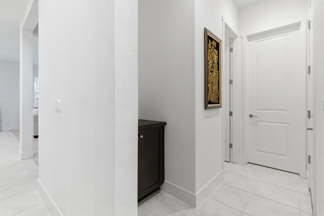 a bathroom with a toilet a sink a mirror a vanity and shower