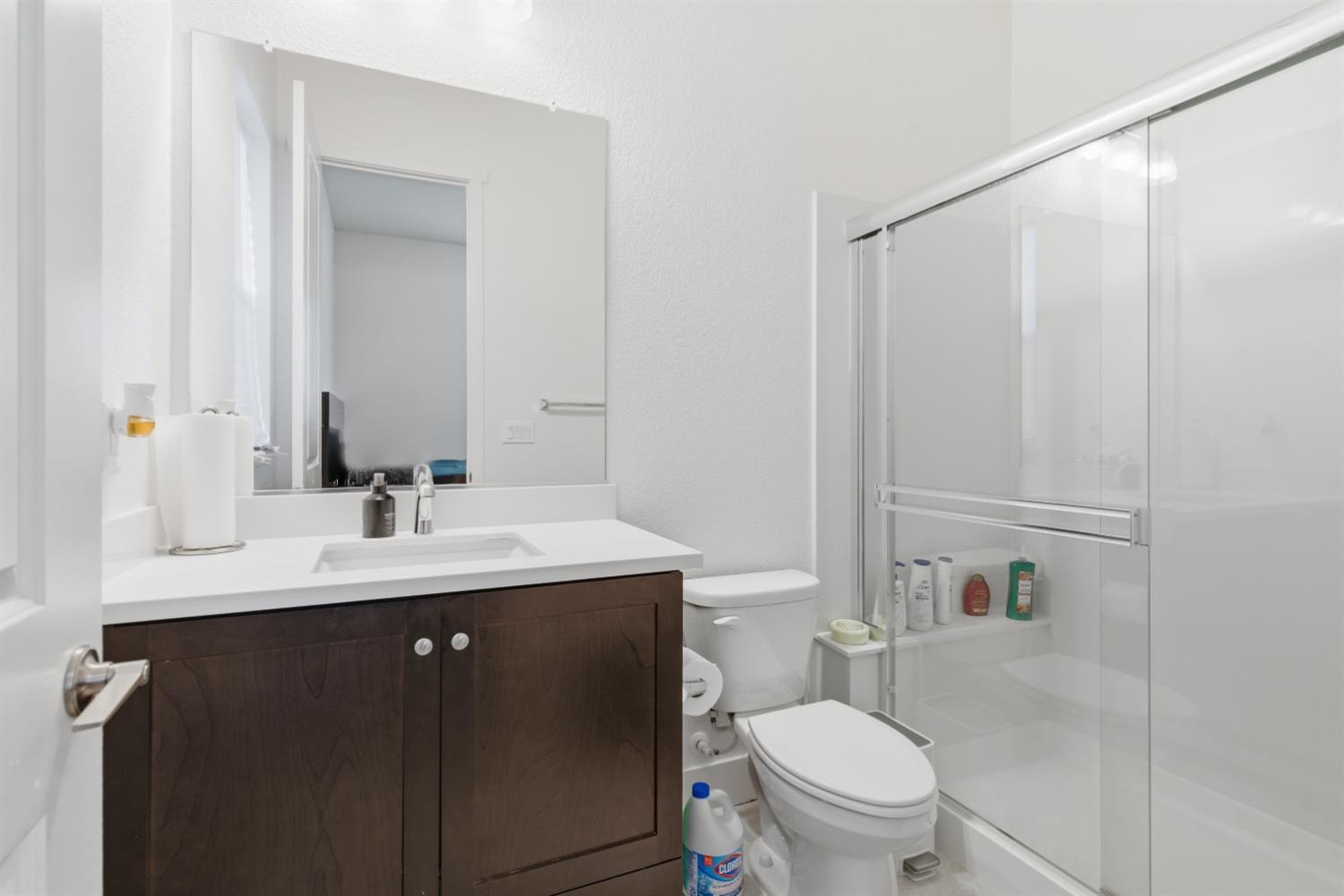 3233 Kipling Drive Lathrop, CA 95330 - Photo 8 of 39 a bathroom with a toilet a sink a mirror a vanity and shower