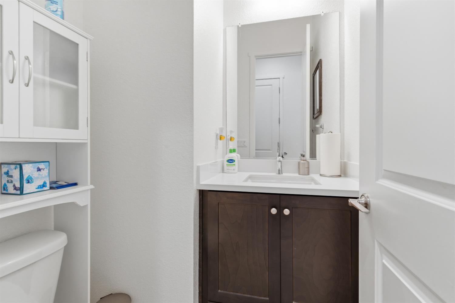 3233 Kipling Drive Lathrop, CA 95330 - Photo 9 of 39 a bathroom with a toilet sink and mirror