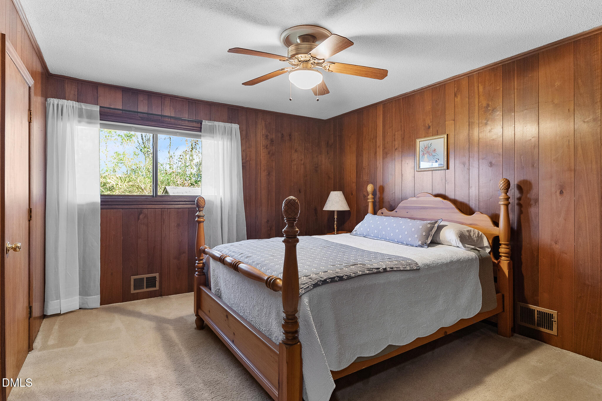 1704 Marshburn Road Wendell, NC 27591 - Photo 14 of 27 a bed room with a bed and a chandelier