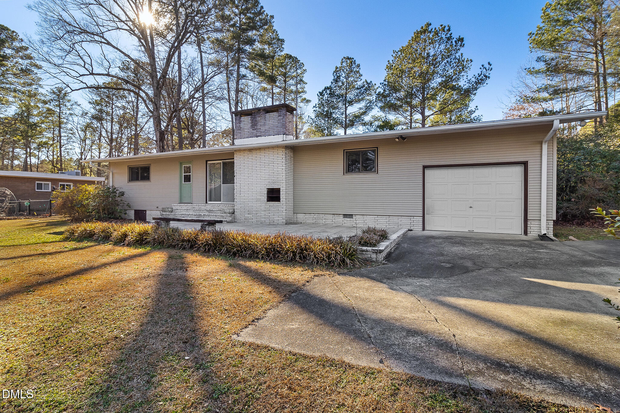 1704 Marshburn Road Wendell, NC 27591 - Photo 22 of 27 a backyard of a house with wooden fence and large trees