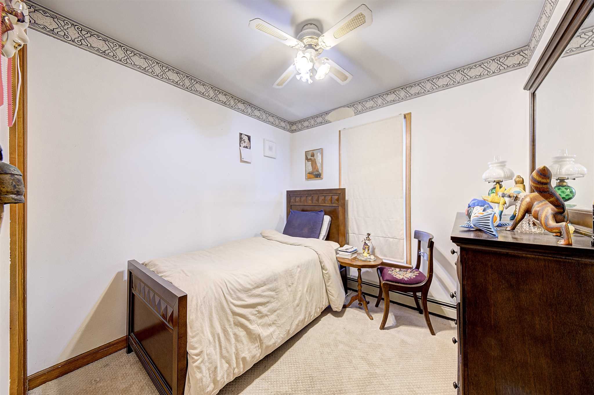 8 Sivers Place Beacon, NY 12508 - Photo 18 of 31 a bedroom with a bed and a chandelier