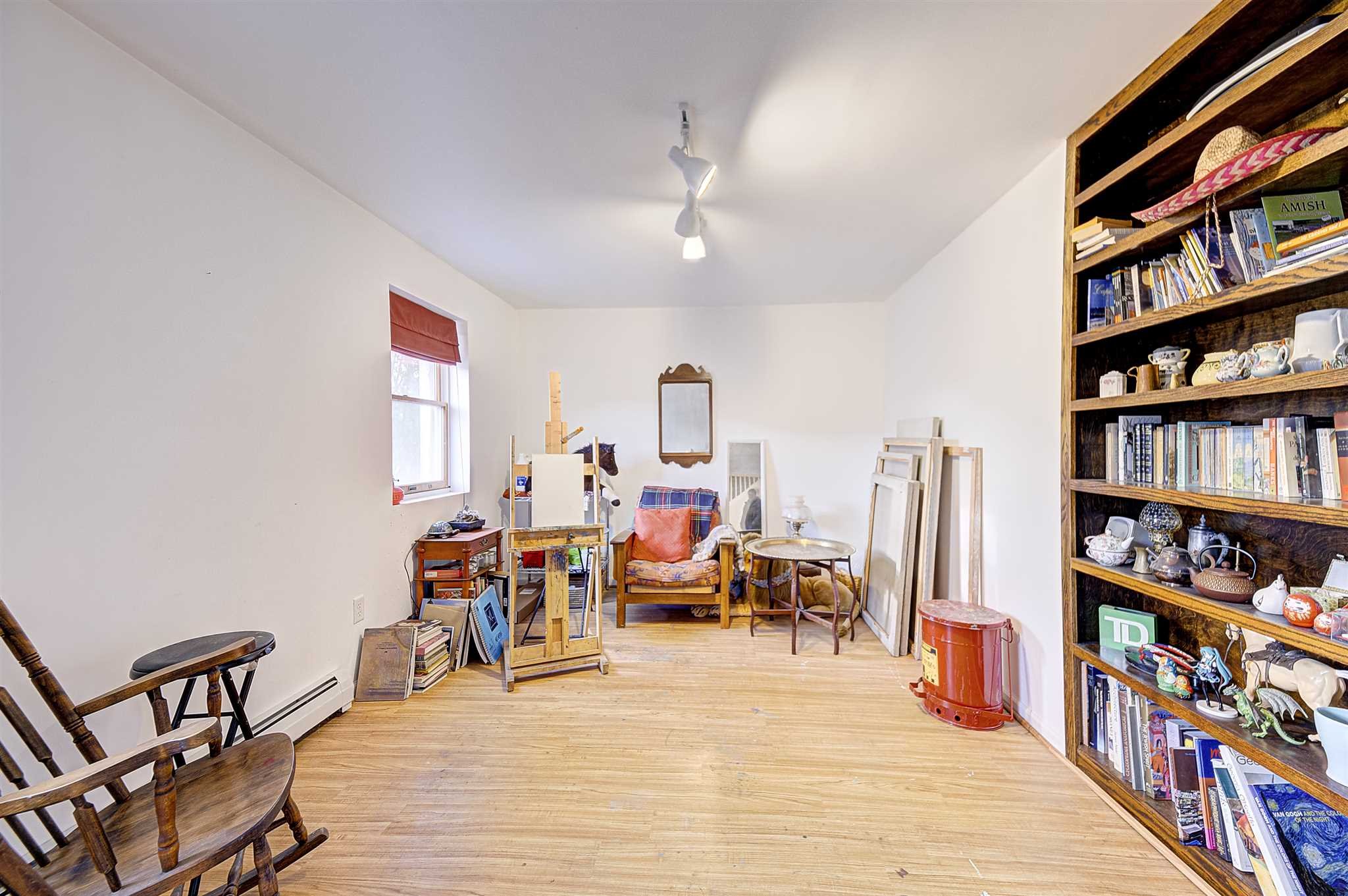 8 Sivers Place Beacon, NY 12508 - Photo 24 of 31 a living room with lots of furniture and a book shelf