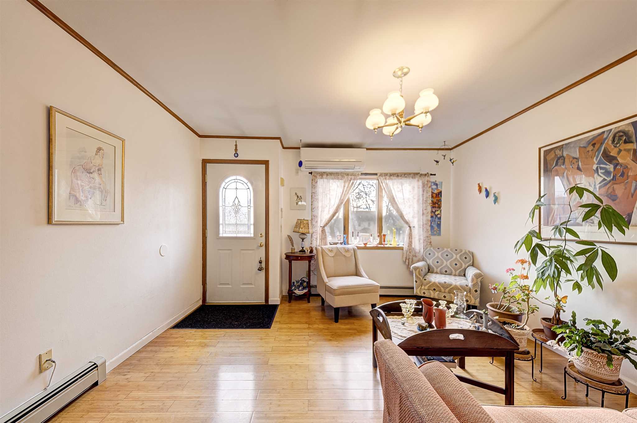 8 Sivers Place Beacon, NY 12508 - Photo 5 of 31 a living room with furniture a chandelier and a window