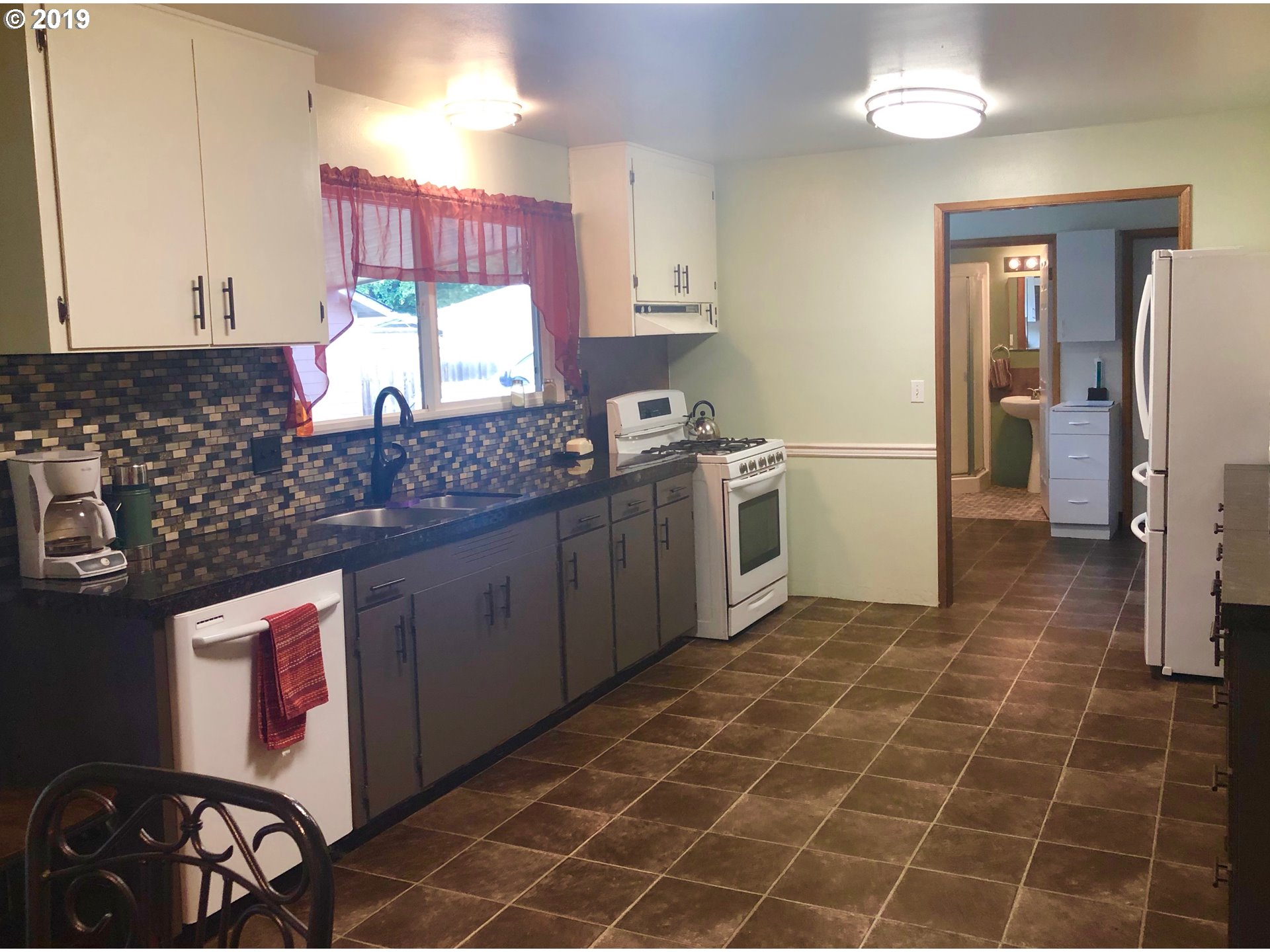 1313 Southwest 39th Street Pendleton, OR 97801 - Photo 4 of 20 a kitchen with a sink cabinets and stove top oven