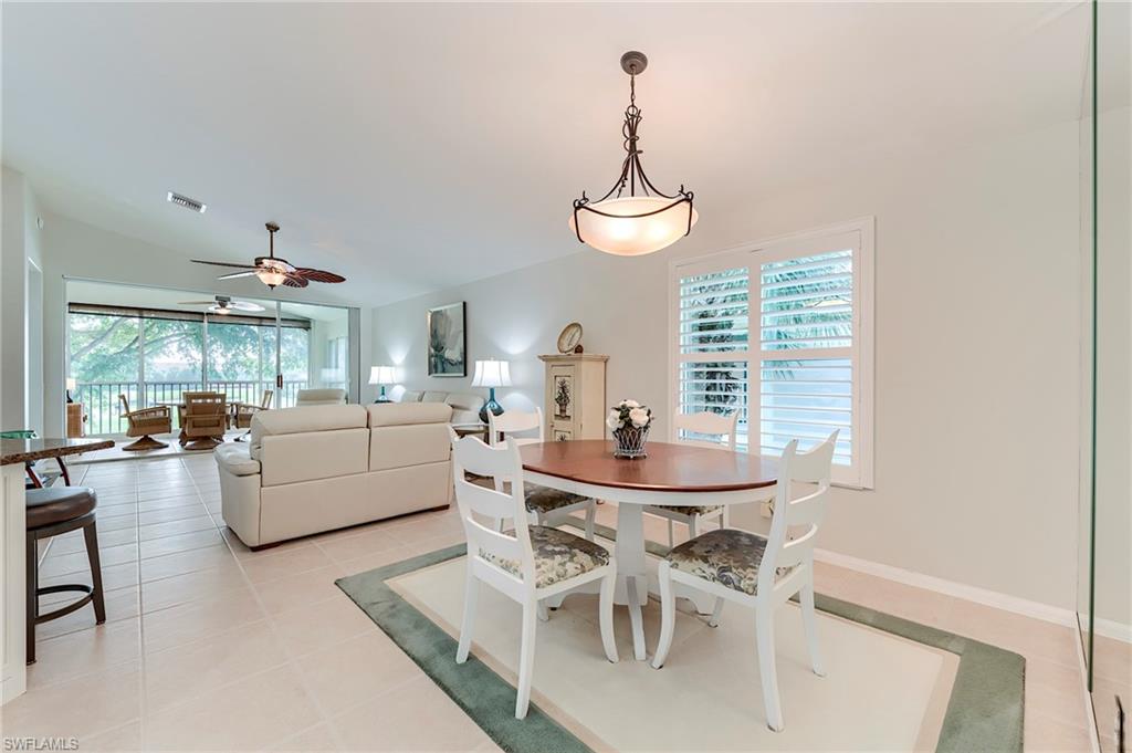 9241 Spring Run Boulevard, Unit 2202 Estero, FL 34135 - Photo 11 of 33 a view of a dining room with furniture wooden floor and chandelier