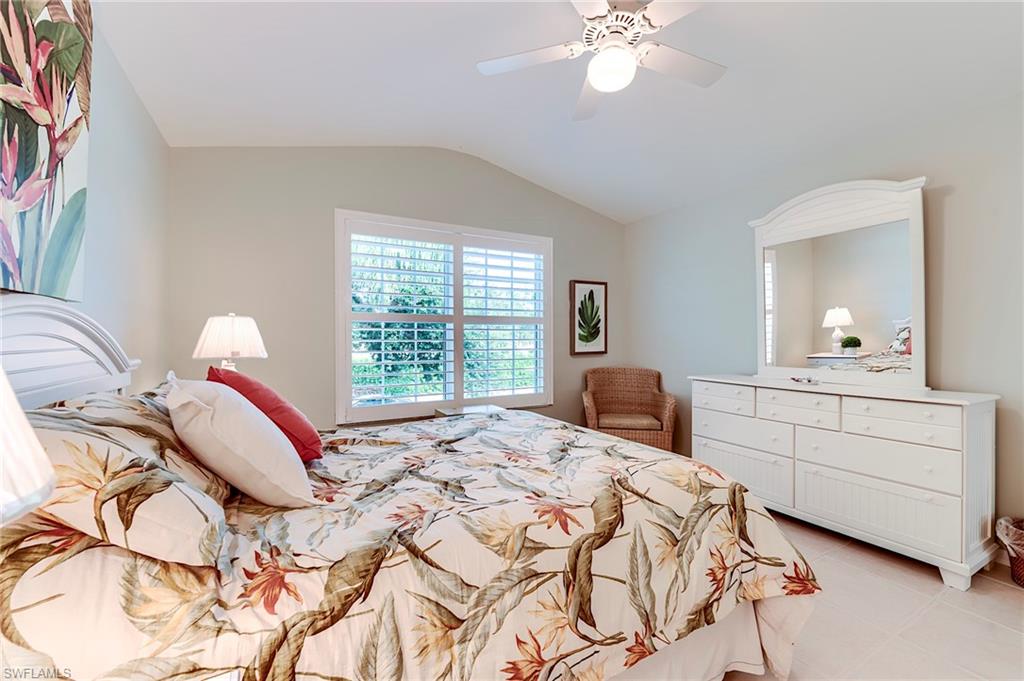 9241 Spring Run Boulevard, Unit 2202 Estero, FL 34135 - Photo 15 of 33 a bedroom with a bed and a chandelier