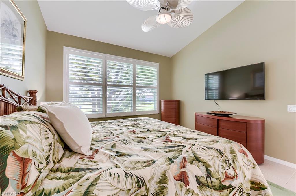 9241 Spring Run Boulevard, Unit 2202 Estero, FL 34135 - Photo 17 of 33 a bedroom with a bed and a flat screen tv