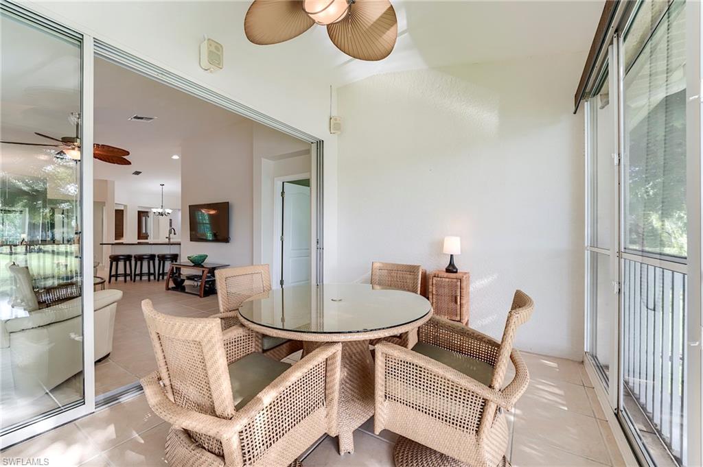 9241 Spring Run Boulevard, Unit 2202 Estero, FL 34135 - Photo 21 of 33 a dining room with furniture and a potted plant