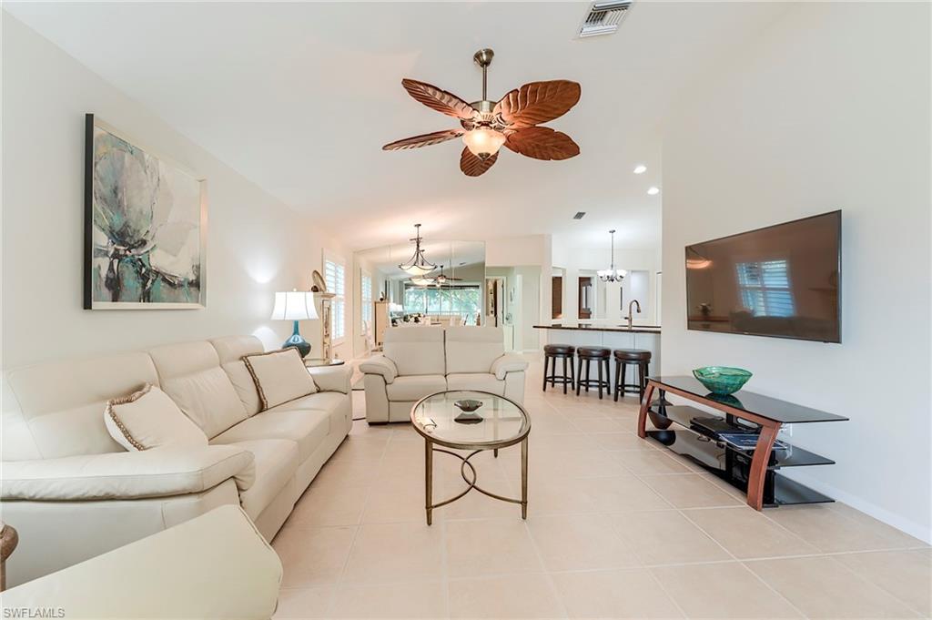 9241 Spring Run Boulevard, Unit 2202 Estero, FL 34135 - Photo 9 of 33 a living room with furniture and a flat screen tv
