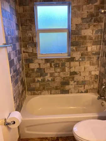 a bathroom with a toilet and a bathtub
