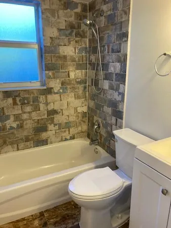 a bathroom with a toilet and a bathtub