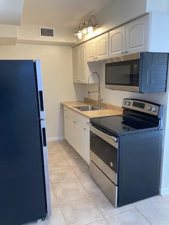 a kitchen with stainless steel appliances a stove and a microwave