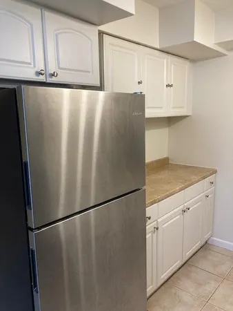a white refrigerator freezer sitting in a kitchen