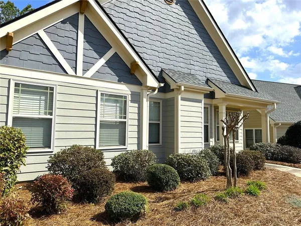 a front view of a house with garden