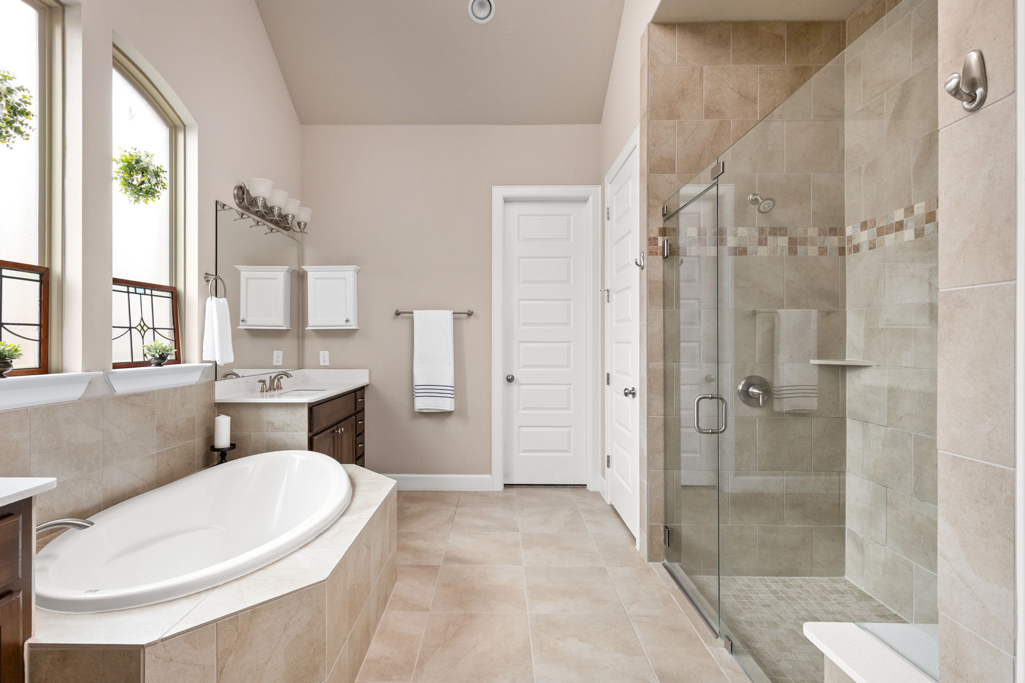 144 Cats Eye Cove Dripping Springs, TX 78620 - Photo 12 of 31 The spa-inspired bathroom features a soaking tub for relaxation.