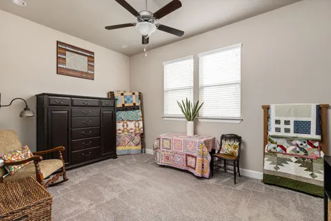 a bathroom with a granite countertop sink a toilet and shower