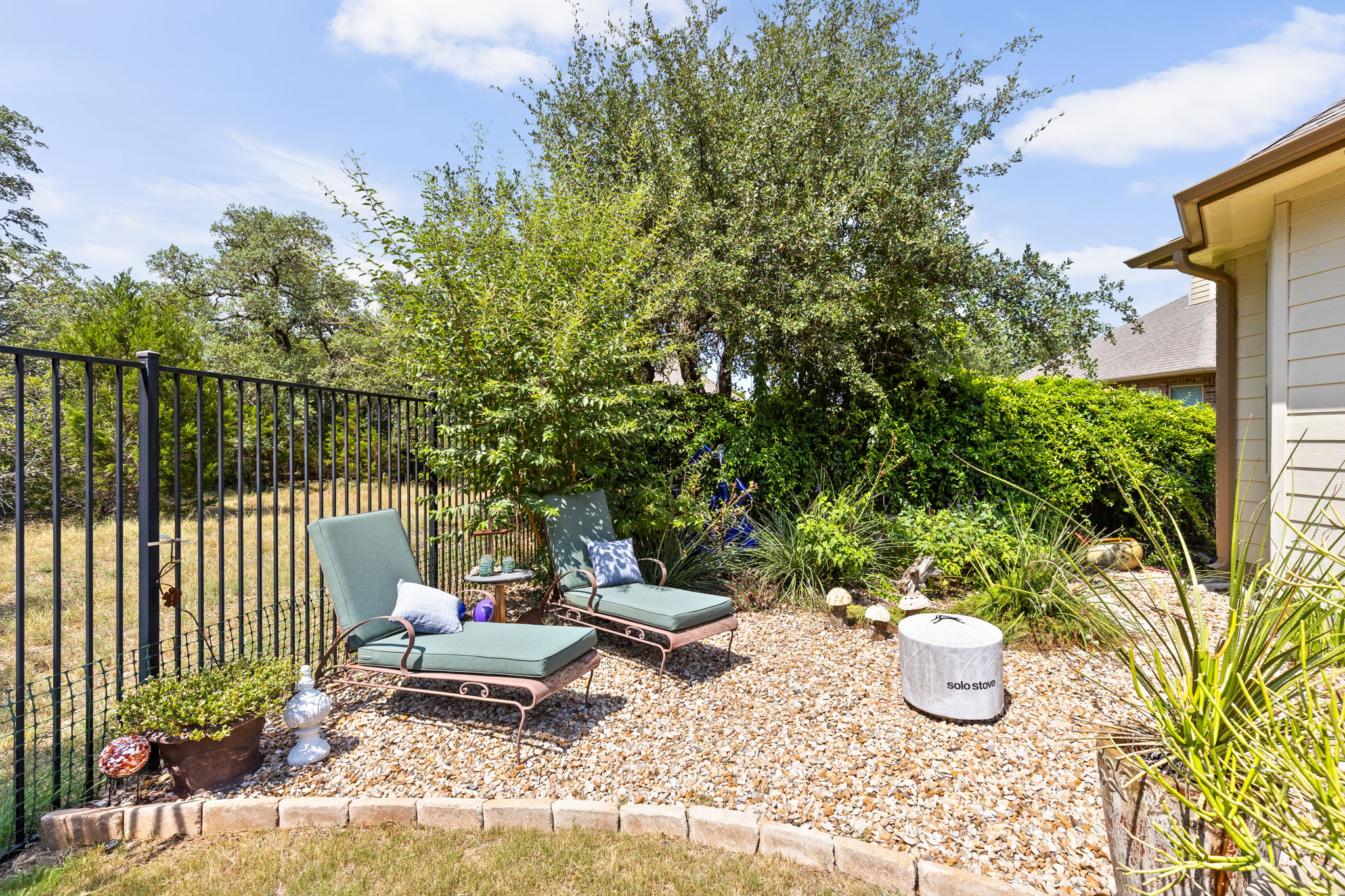 144 Cats Eye Cove Dripping Springs, TX 78620 - Photo 27 of 31 Lush landscaping creates a peaceful outdoor retreat.