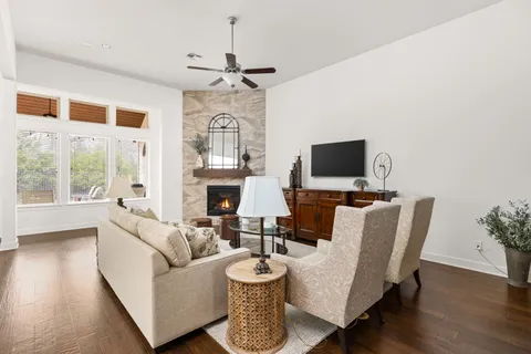 a living room with fireplace furniture and a flat screen tv
