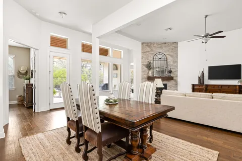 a bedroom with a bed and a table in it with window
