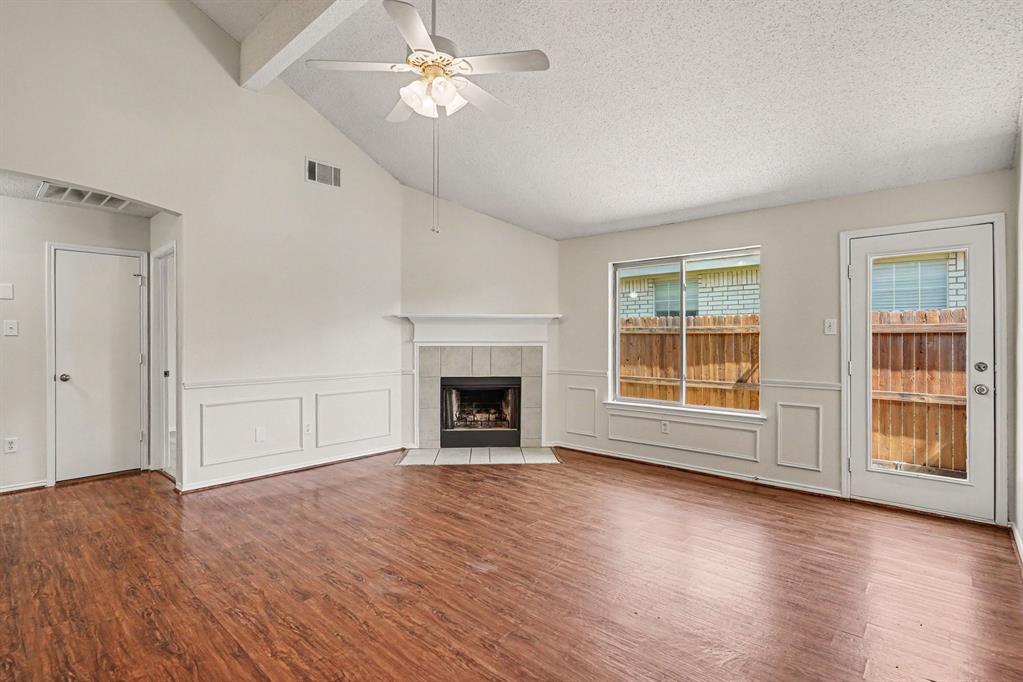 2541 Rivers Edge Drive Fort Worth, TX 76118 - Photo 4 of 31 a view of empty room with wooden floor and fireplace