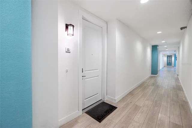 a kitchen with stainless steel appliances a dining table chairs stove and white cabinets