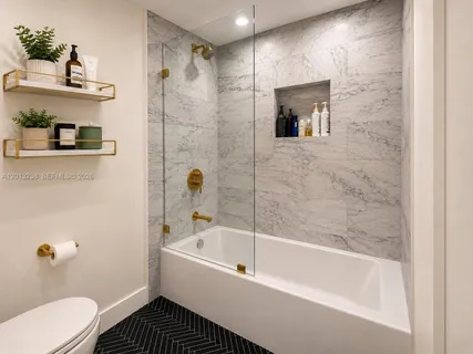 a bathroom with a bathtub and a shower